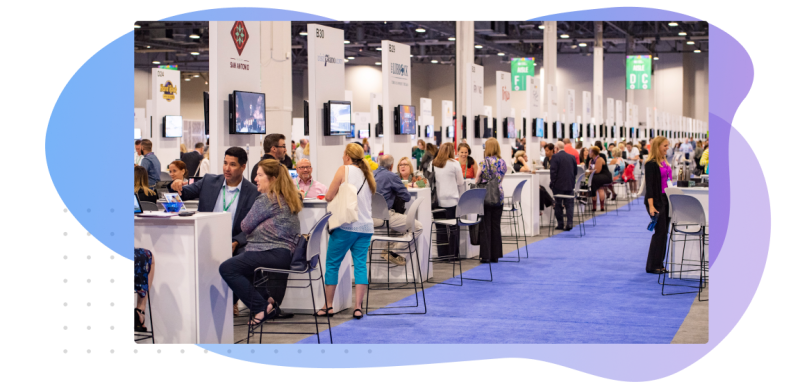 Exhibitors talking with attendees in a conference hall