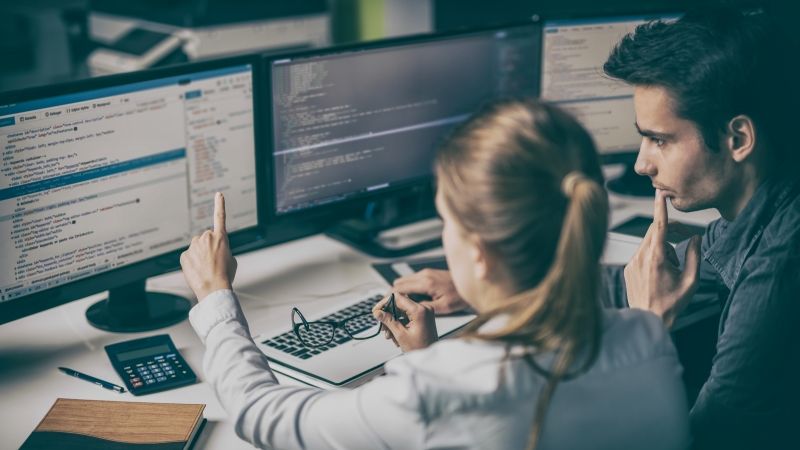 People looking at data on computer