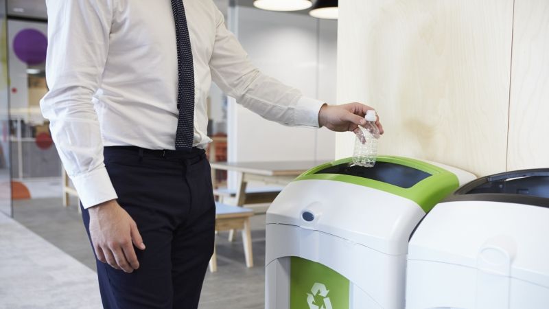 man recycling water bottle