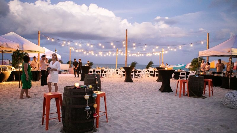 event on beach with string lighting