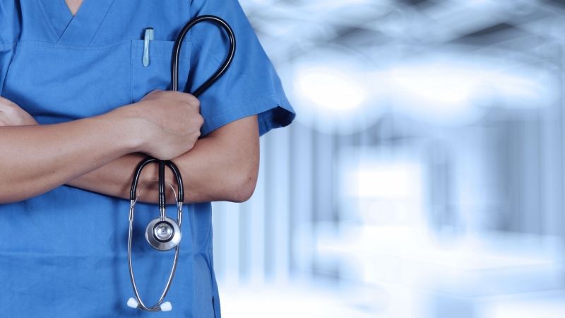 Healthcare worker holding stethoscope