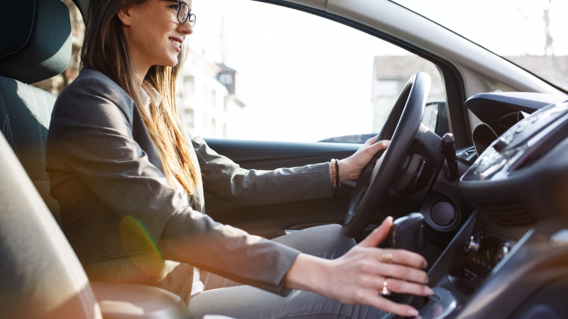 businesswoman driving car to meeting