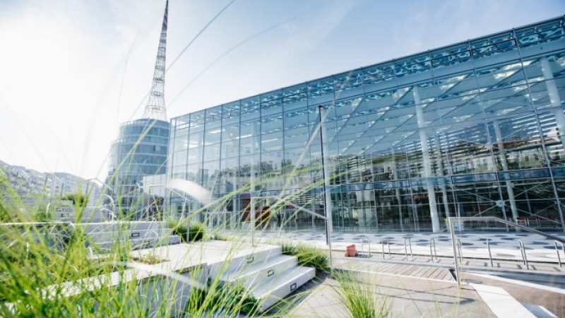 outside of glass exhibition center with grass in foreground