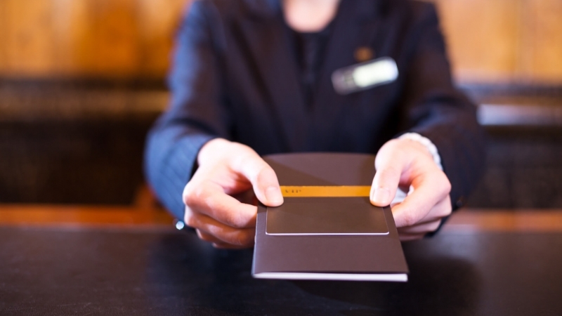 hotel employee handing over credit card