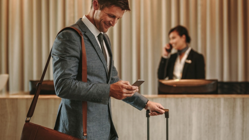 hotel guest smiling looking at mobile device