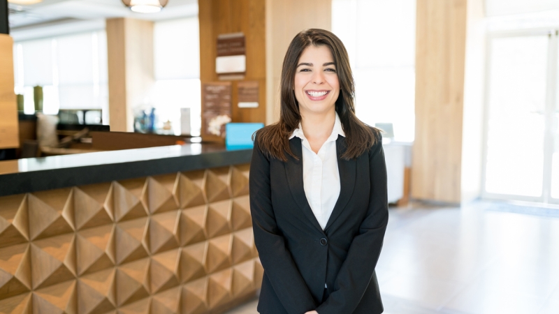 smiling hotel manager in lobby