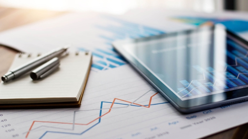 Chart of pricing strategy data shown on paper and tablet on table