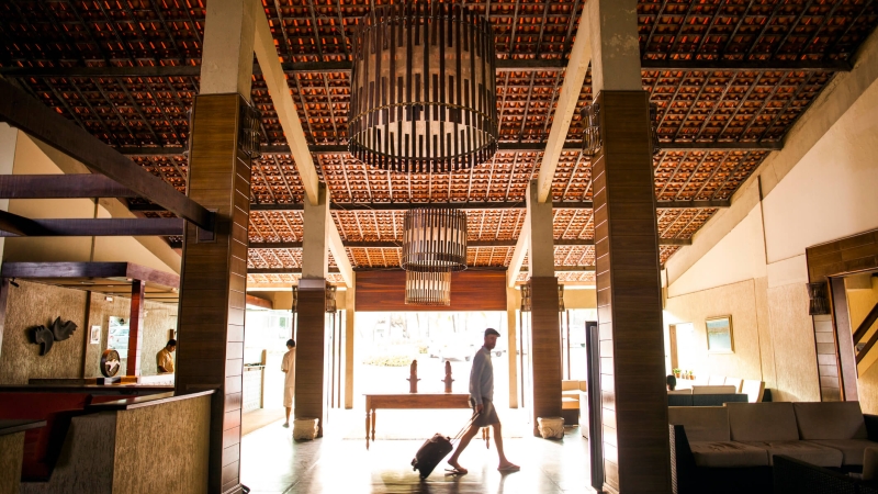 man walks through a hotel lobby