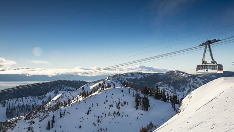 gondola going through snow-covered mountains 