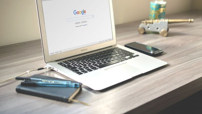 laptop on desk with google search page on screen