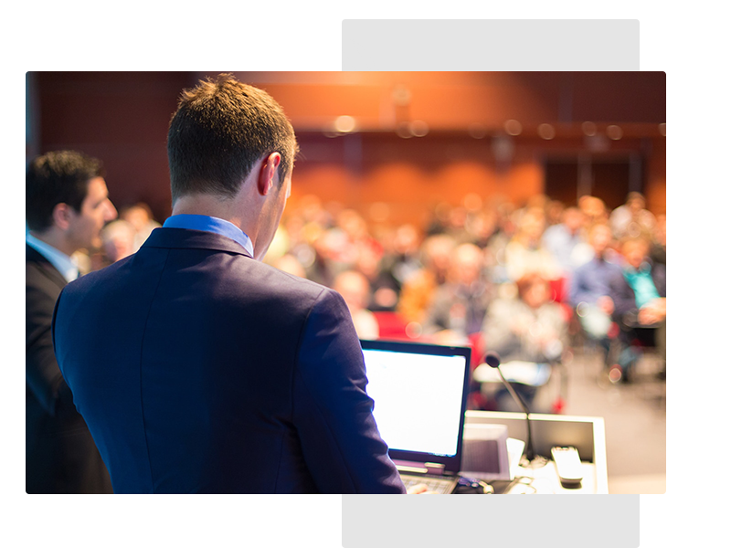 man presenting from computer at conference