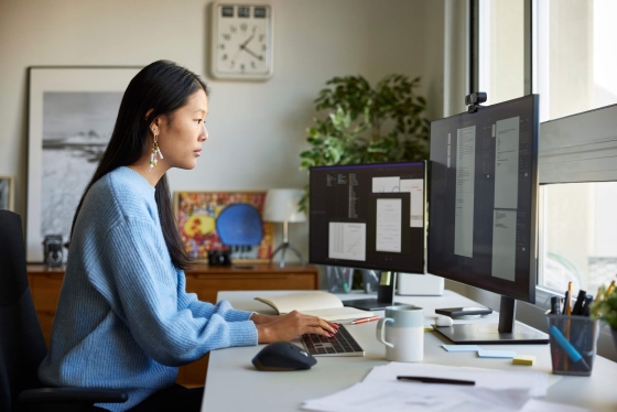 woman on a computer with many documents